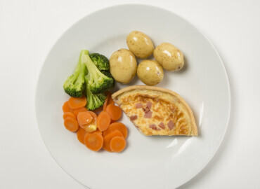 Shop bought quiche with potatoes and vegetables