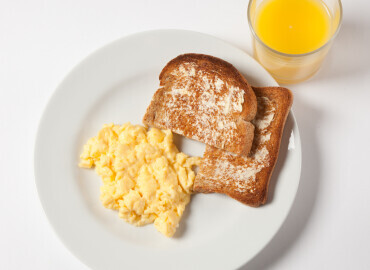 Scrambled egg, slice of wholemeal toast and lower fat spread, and a glass of fresh orange juice