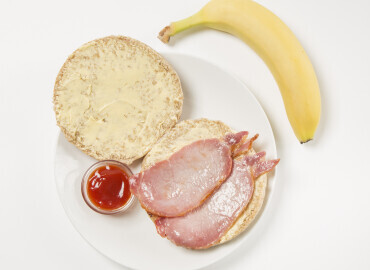 Bacon roll with tomato ketchup followed by a banana