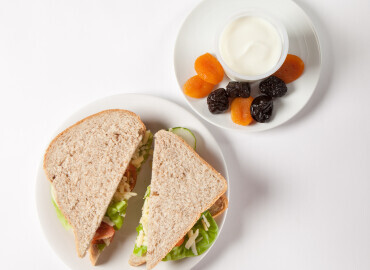Cheese and salad sandwich on wholemeal bread followed by yogurt and dried fruit