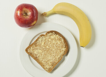 Banana, apple, and slice of toast with lower fat spread